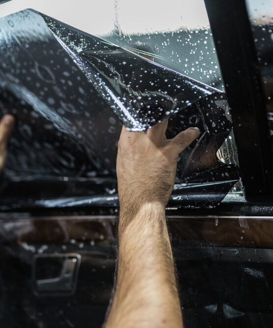 Car,Tinting,-,Worker,Applying,Tinting,Foil,On,Car,Window. Car,Tinting,-,Worker,Applying,Tinting,Foil,On,Car,Window.